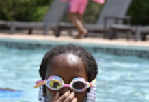 Young girl swimming with goggles